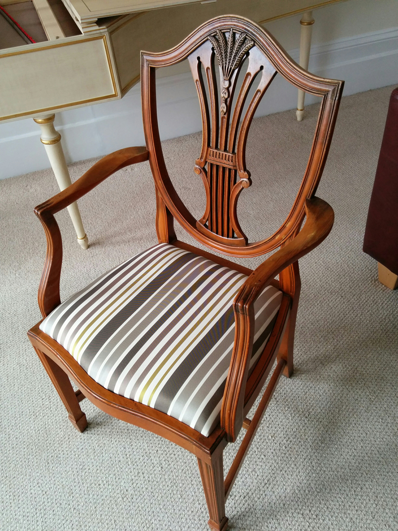 The finished chair with reupholstered seat.