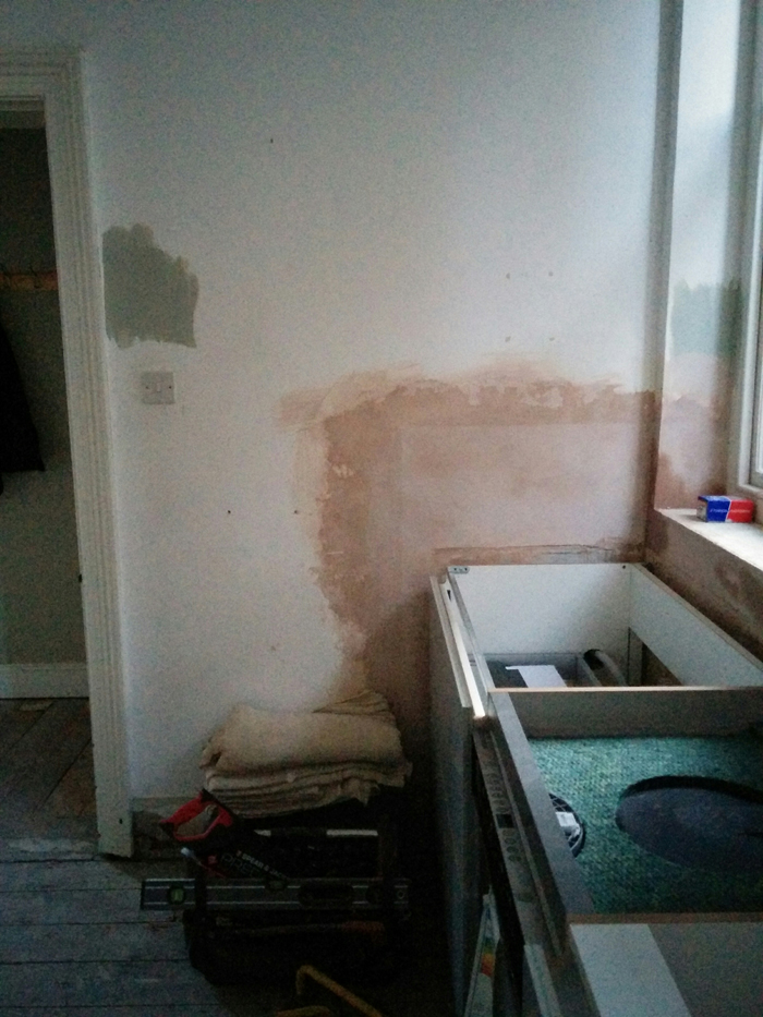 plastering to the wall by the sink