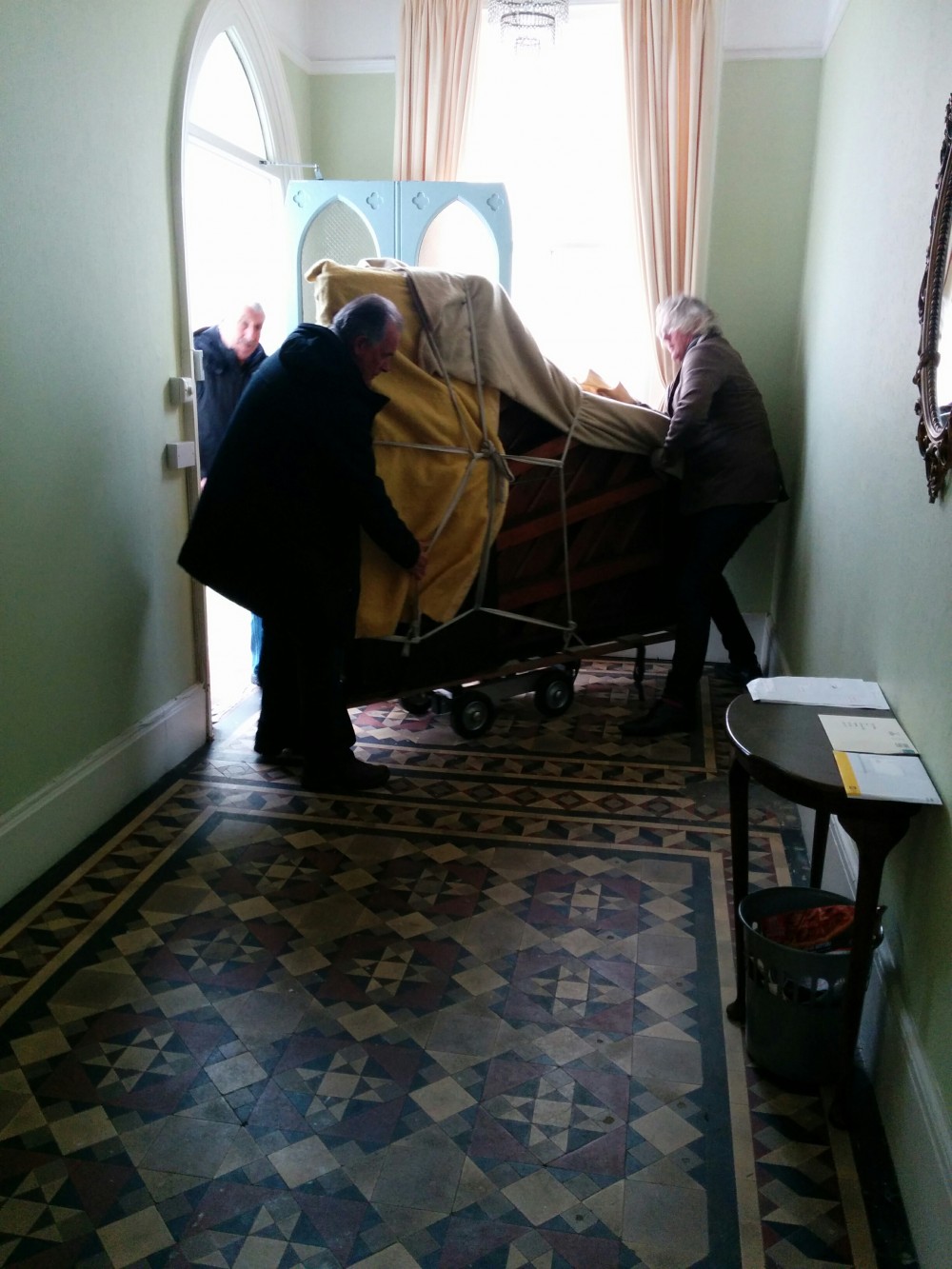 Putting the piano onto the wheeled trolley